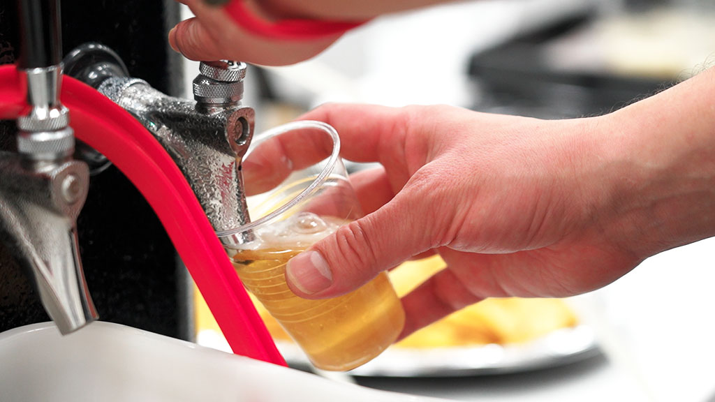 Pouring from the tap and chatting with guests